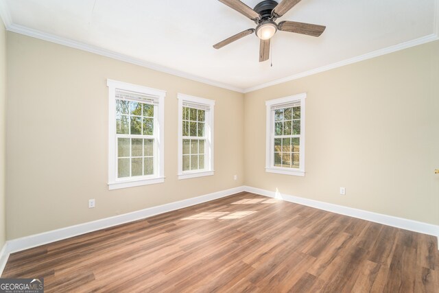 424 NW Central Ave, Blackshear, GA 31516 - empty room featuring baseboards, ornamental molding, dark wood-style flooring, and a ceiling fan