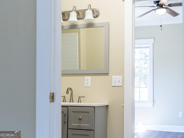 424 NW Central Ave, Blackshear, GA 31516 - kitchen with crown molding, a sink, a healthy amount of sunlight, visible vents, and dark wood-style floors