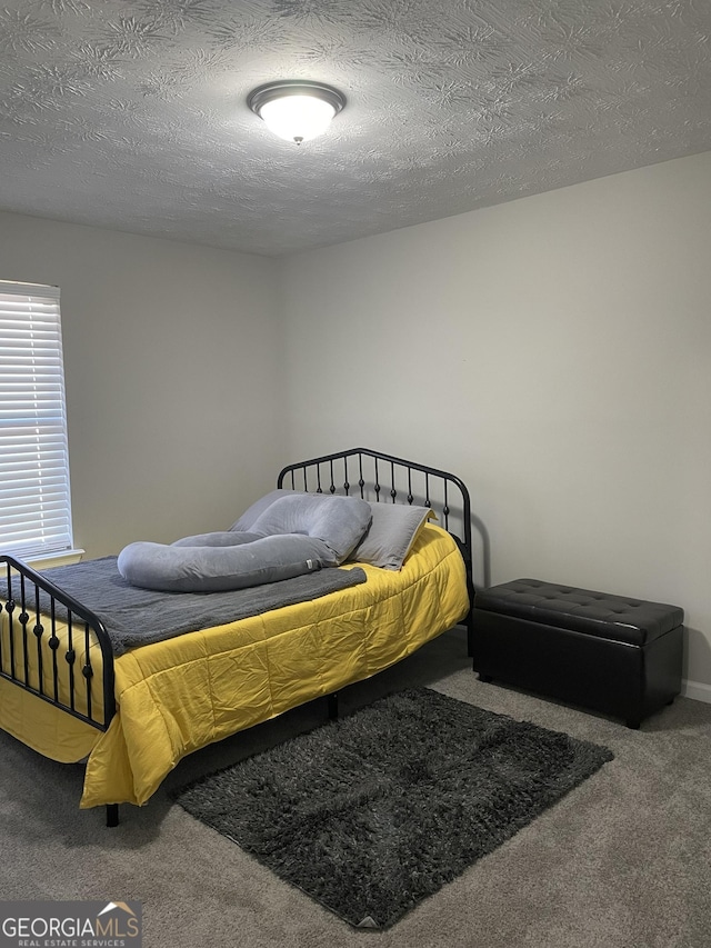 carpeted bedroom featuring a textured ceiling