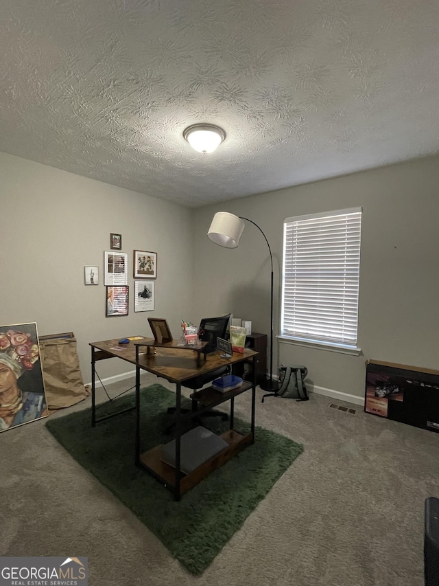 office area featuring carpet floors and a textured ceiling