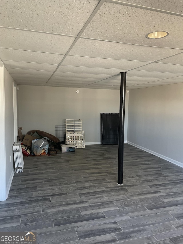 basement with dark hardwood / wood-style floors