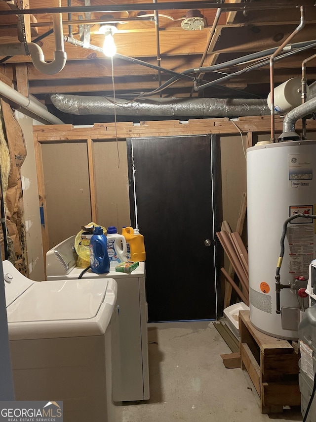 basement featuring washing machine and dryer and water heater