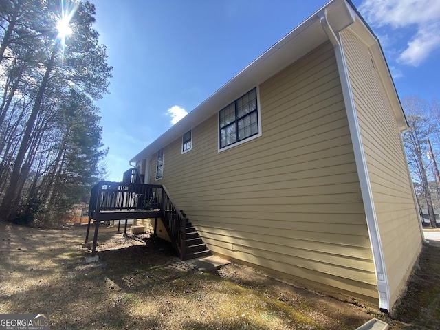 view of property exterior with a deck