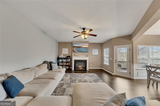 living room featuring dark wood-type flooring and ceiling fan