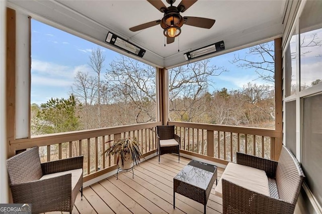 wooden terrace featuring outdoor lounge area and ceiling fan