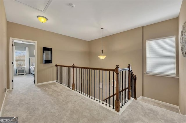 hall featuring light colored carpet