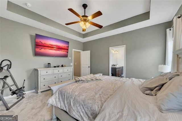 bedroom with a raised ceiling and ceiling fan