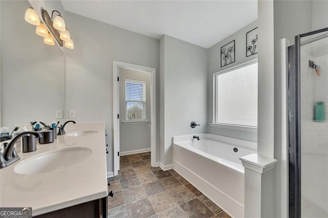 bathroom featuring vanity and a washtub