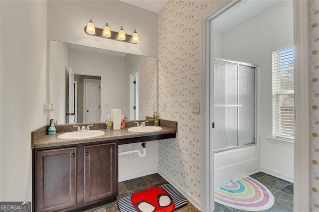 bathroom featuring enclosed tub / shower combo, plenty of natural light, and vanity