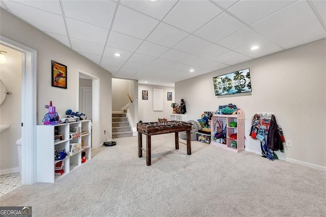 game room with carpet flooring and a drop ceiling