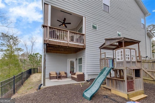 view of playground featuring an outdoor hangout area, ceiling fan, and a patio area