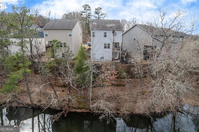 rear view of property featuring a water view