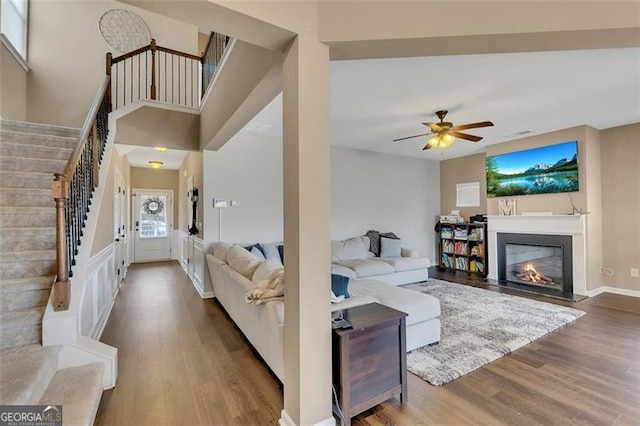 living room with ceiling fan and wood-type flooring