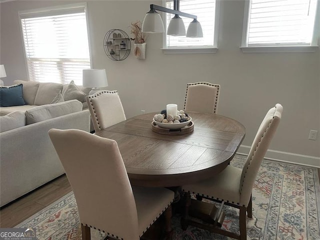 dining room with hardwood / wood-style floors and a healthy amount of sunlight