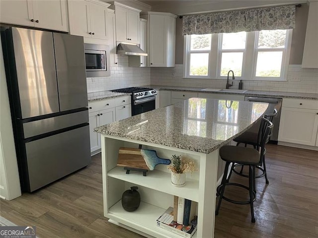 kitchen with white cabinetry, sink, a center island, and appliances with stainless steel finishes