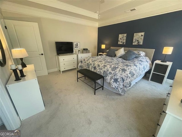 bedroom featuring light carpet, crown molding, and a tray ceiling