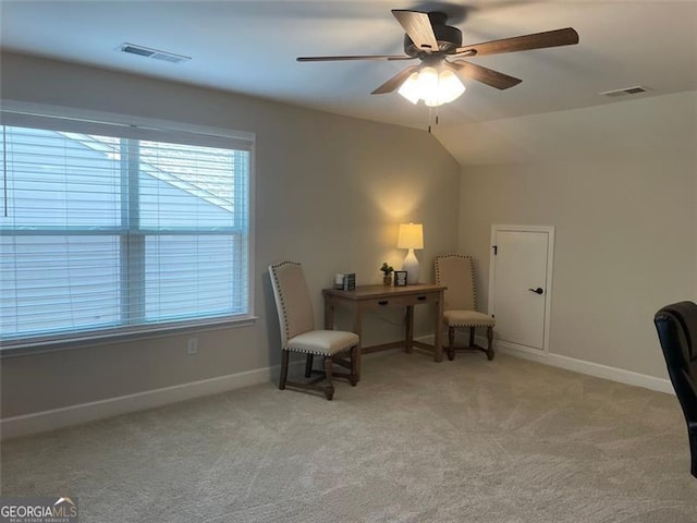 living area featuring light carpet, lofted ceiling, and ceiling fan