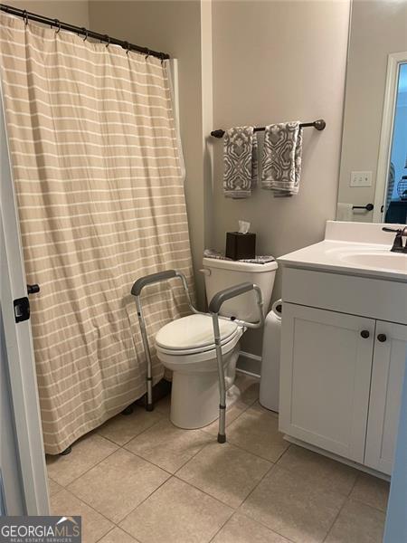 bathroom with tile patterned floors, toilet, and vanity