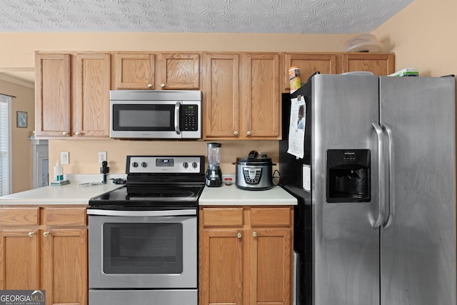 kitchen featuring light brown cabinets, a textured ceiling, and appliances with stainless steel finishes