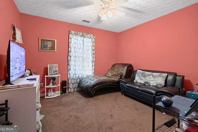 bedroom featuring ceiling fan, carpet flooring, and a textured ceiling