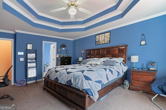 carpeted bedroom featuring crown molding, ceiling fan, and a raised ceiling