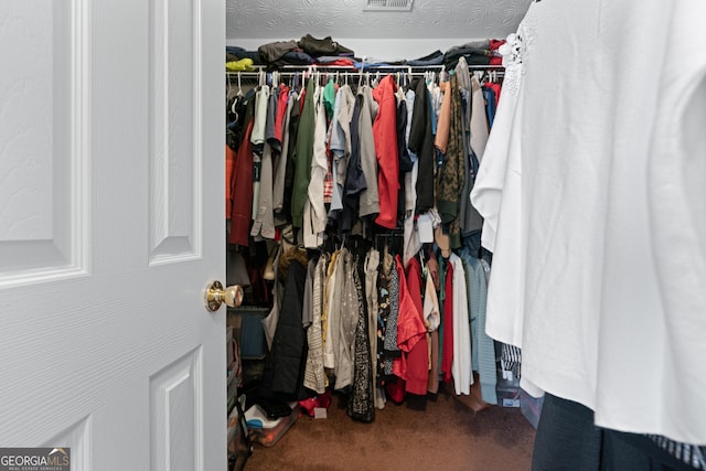 walk in closet with carpet floors