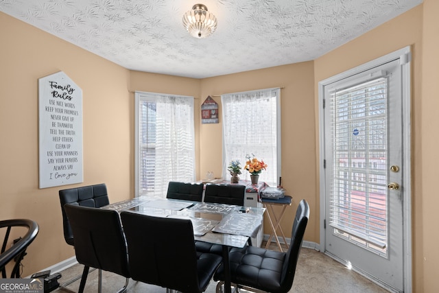 dining space with a textured ceiling