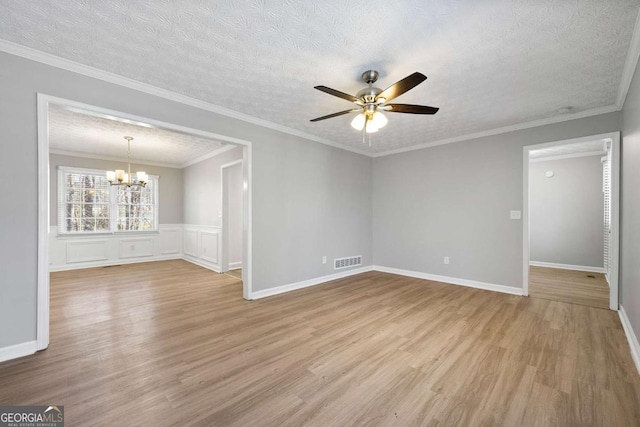 unfurnished room featuring ornamental molding, ceiling fan with notable chandelier, a textured ceiling, and light hardwood / wood-style flooring