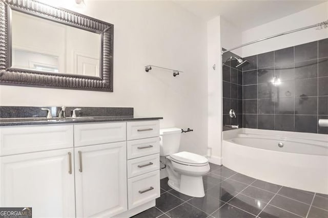 full bathroom featuring tile patterned floors, vanity, toilet, and tiled shower / bath combo