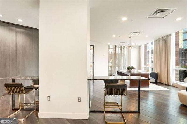 dining area with expansive windows and dark hardwood / wood-style floors