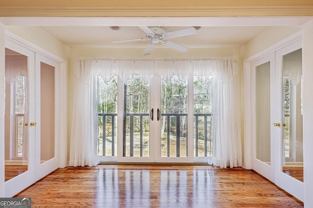 unfurnished sunroom featuring french doors and ceiling fan