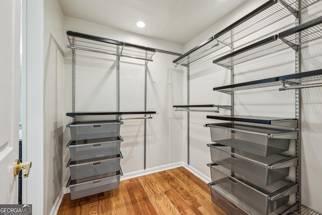 spacious closet featuring hardwood / wood-style floors