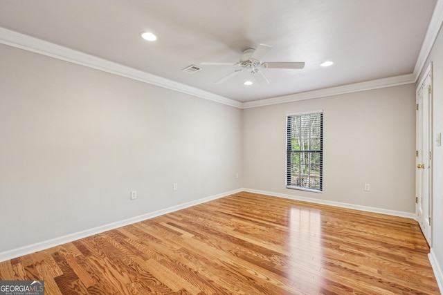 spare room with crown molding, ceiling fan, and light wood-type flooring