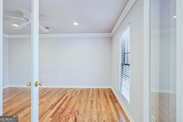 unfurnished room featuring french doors, ornamental molding, and light wood-type flooring