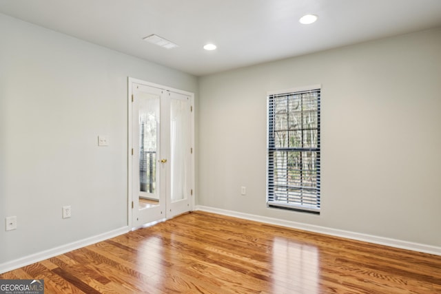 unfurnished room featuring hardwood / wood-style floors