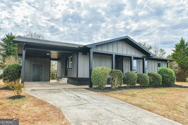 view of front facade with a carport and a front lawn