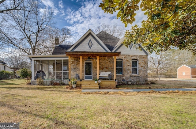 view of front of property with a sunroom and a front yard