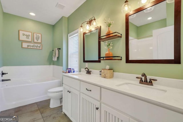 bathroom featuring vanity, a bath, tile patterned floors, and toilet