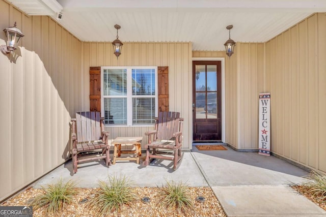 view of exterior entry featuring covered porch