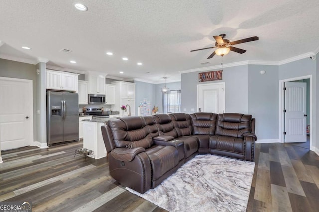 living room featuring crown molding, ceiling fan, a textured ceiling, and dark hardwood / wood-style flooring