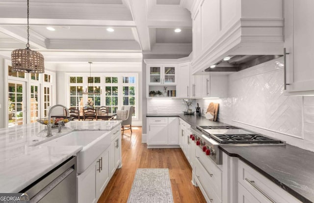 kitchen with pendant lighting, appliances with stainless steel finishes, custom exhaust hood, and white cabinets