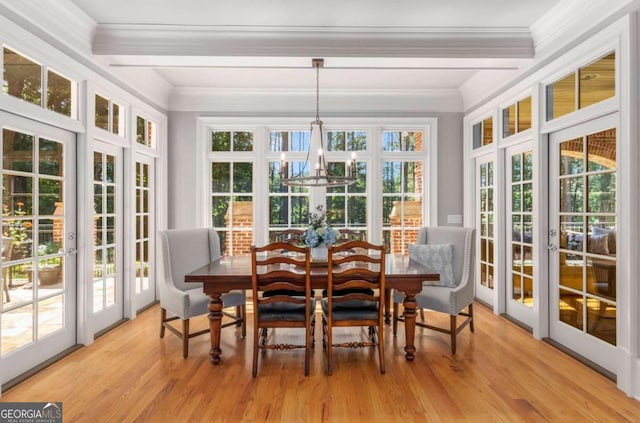 sunroom / solarium with beam ceiling, french doors, and a chandelier