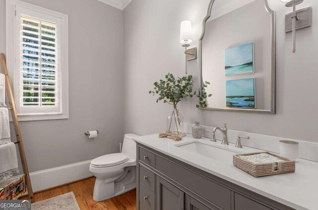 bathroom with vanity, hardwood / wood-style floors, and toilet