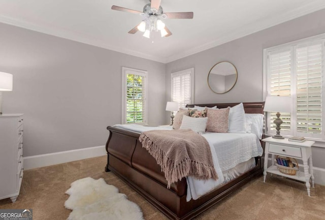 carpeted bedroom featuring ornamental molding and ceiling fan