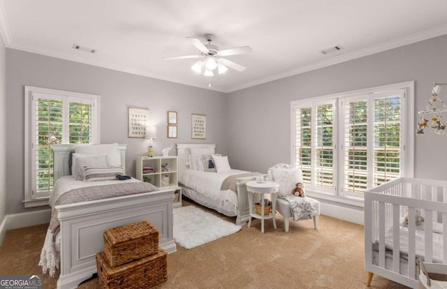 bedroom with light carpet, crown molding, and ceiling fan