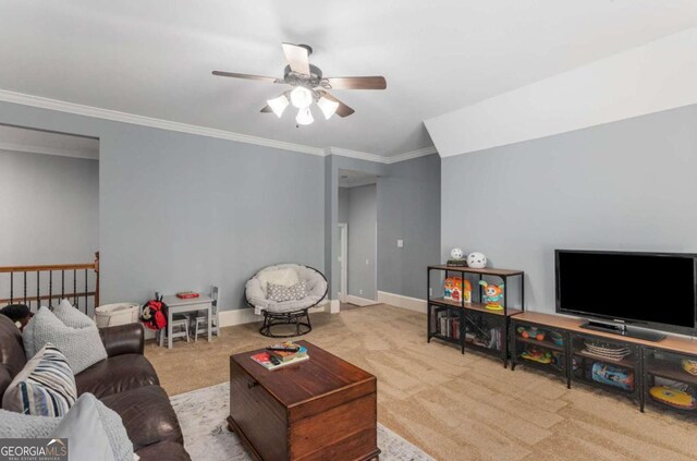 carpeted living room with ceiling fan and ornamental molding