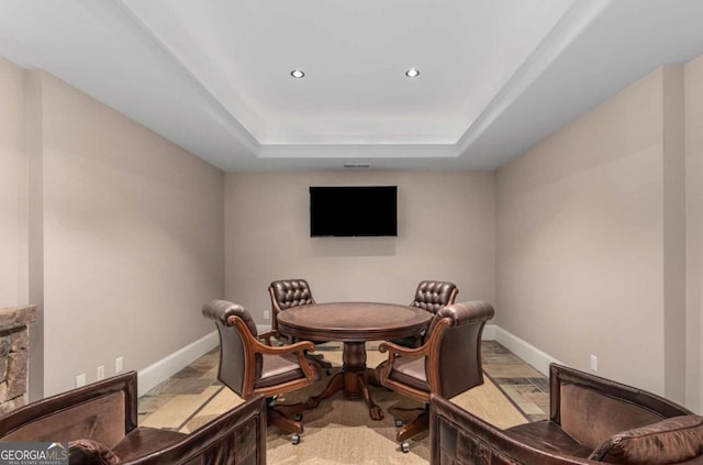 dining room with a raised ceiling