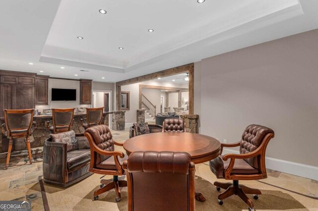 dining area with a raised ceiling