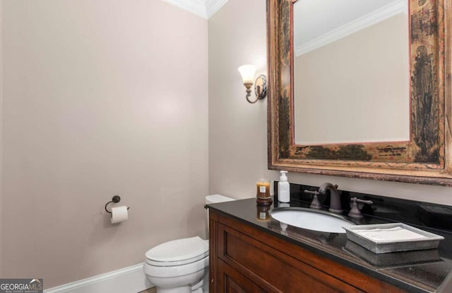 bathroom featuring vanity, ornamental molding, and toilet