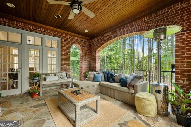 sunroom / solarium with ceiling fan and wooden ceiling